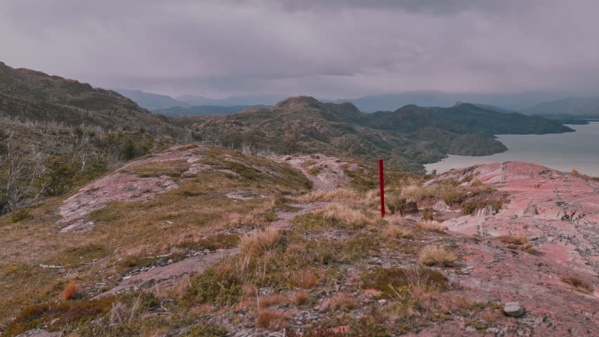 Rising above a rugged Patagonia landscape with trail markers showing the way on the W Trek in Torres del Paine, Chile
