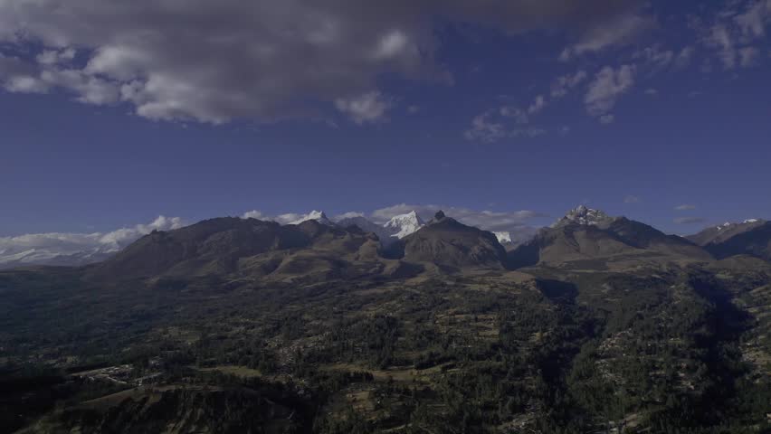 Aerial view of the snow-capped Andes mountains and rugged terrain in Ancash, Peru.