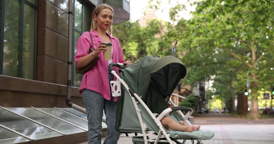 Baby carriage. Mother walking with her child in stroller outdoors