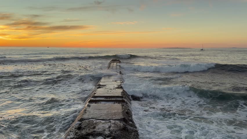 An old pier going out to sea In Mouille Point, Sea Point Cape Town.