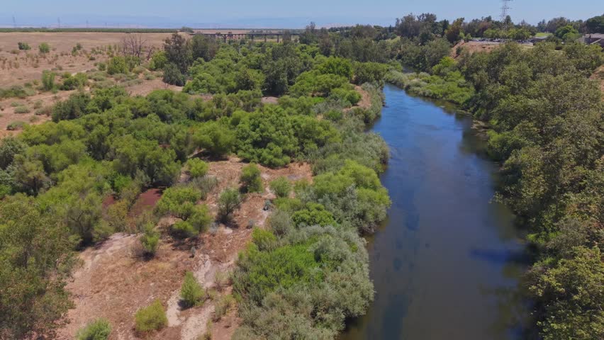 Forward moving aerial drone footage tracking over the San Joaquin River in California