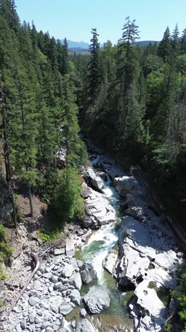 Granite Falls, Washington State, USA — Aerial drone photography of a scenic waterfall surrounded by dense evergreen forest and rocky terrain in the Pacific Northwest. Beautiful summer wilderness landscape with cascading water, natural beauty, and a peaceful outdoor atmosphere