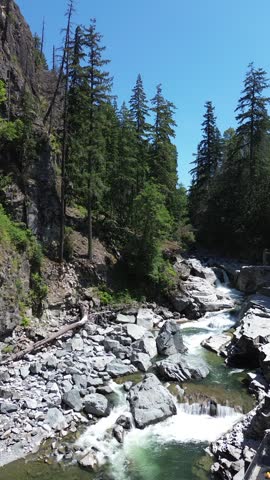 Granite Falls, Washington State, USA — Aerial drone photography of a scenic waterfall surrounded by dense evergreen forest and rocky terrain in the Pacific Northwest. Beautiful summer wilderness landscape with cascading water, natural beauty, and a peaceful outdoor atmosphere