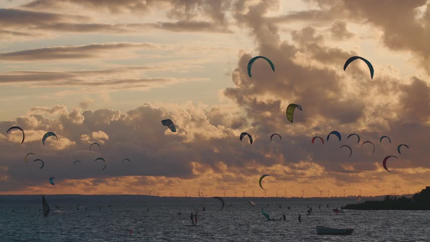 professional kite surfing on ocean or sea sunset, kitesurfing training at water, Jastarnia Poland 4k