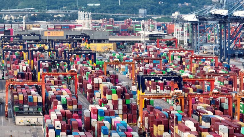 4K aerial view of massive container ship and gantry cranes at Shenzhen Port, global maritime trade hub in China.