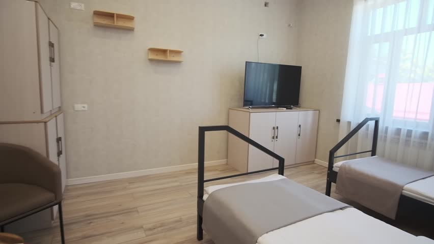 A guest room with two beds in a small cozy hotel. No people