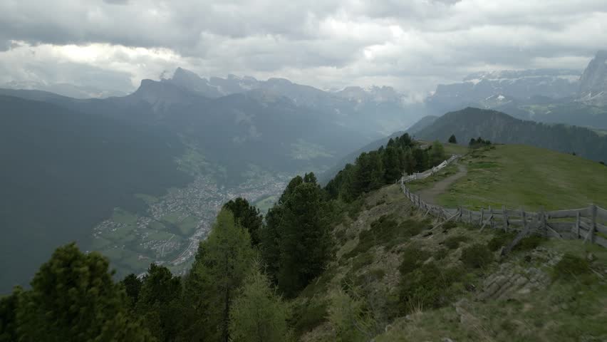 An aerial view of Urtijei town of in South Tyrol in northern Italy. It occupies the Val Gardena within the Dolomites on a cloudy day