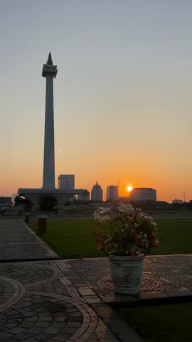 Jakarta, Indonesia - July 16, 2026: Sunset at the National Monument (Monas) in Jakarta, with a view of high-rise buildings.