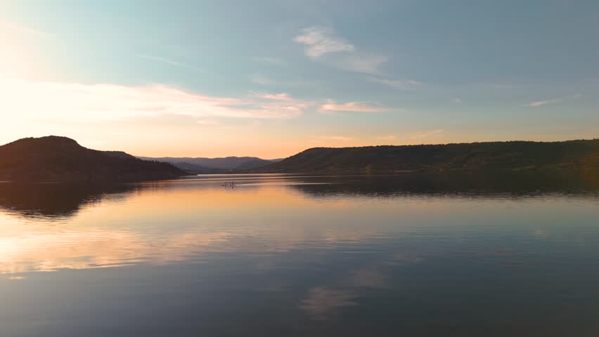 Drone Dolly In Above Lake with Canadair Firefighting Planes at Sunset Near Water Surface