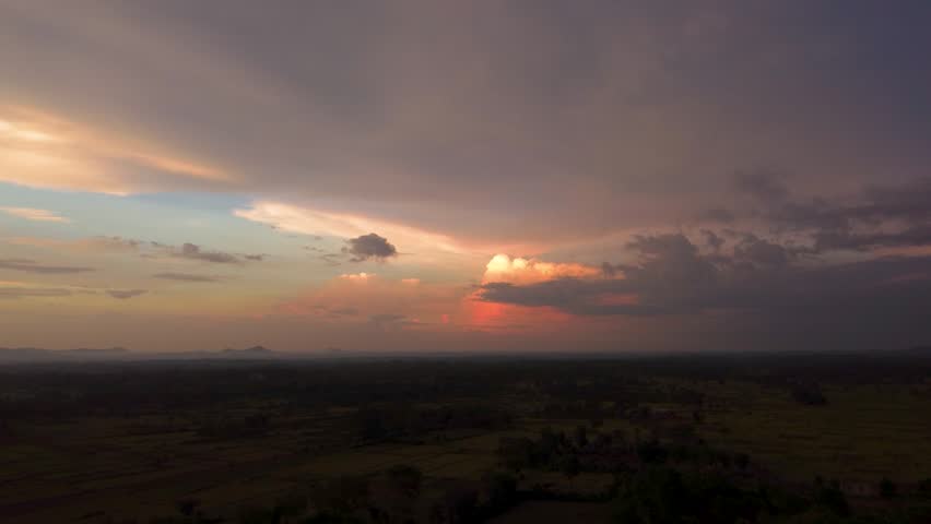 Sunset sky with dramatic clouds, aerial view, scenic landscape.