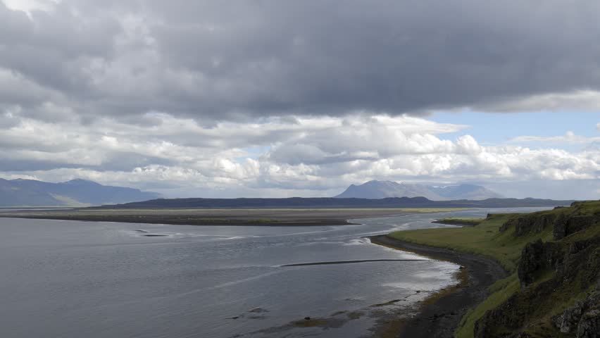 Wide Panoramic Icelandic Coastal Landscape Under Dramatic Clouds 4K Nature Footage