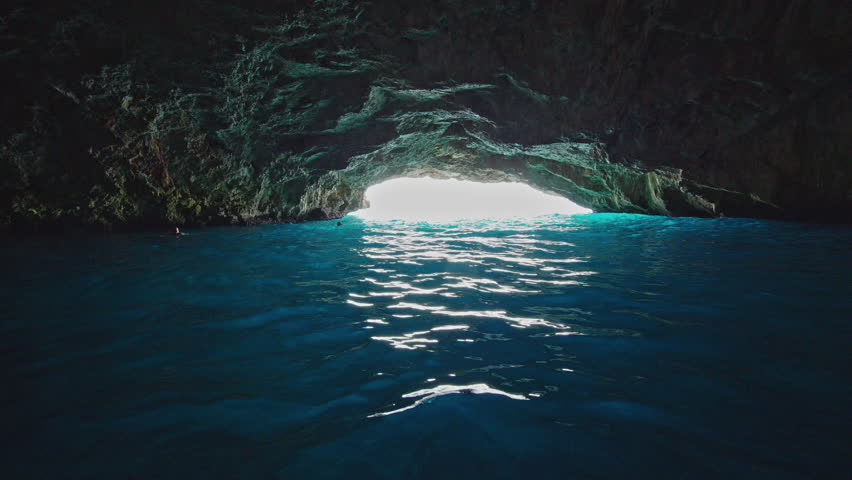 Blue Cave with turquoise water on the Lustica Peninsula in Montenegro. View from inside the famous sea cave illuminated by natural light reflecting from the Adriatic Sea near the entrance to the Bay