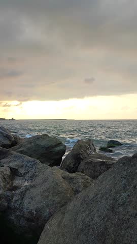 the waves crashing against the rocks and shore