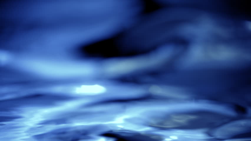 Absrtract blue water macro background with gradient liquid on dark backdrop. 3D animation wave fluid swirling backplate with copy space. Elegant seamless loop texture.