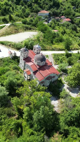 Aerial view of leaning Panagia church affected by massive landslide in abandoned sinking village of Ropoto Thessaly Greece for disaster and architecture video. High quality 4k footage