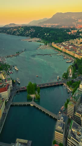 Establishing shot of Geneva city. Aerial view of the Swiss lake town. Rooftops of houses and the lake bay