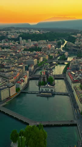 Establishing shot of Geneva city. Aerial view of the Swiss lake town. Rooftops of houses and the lake bay