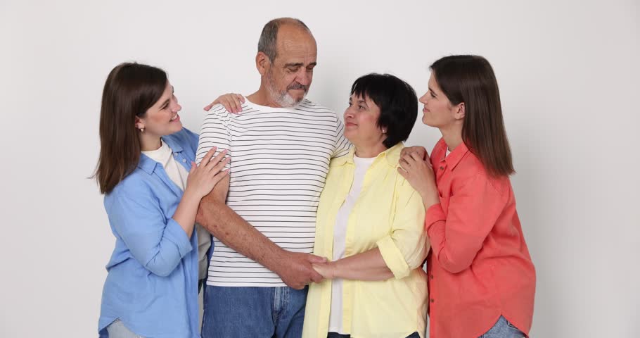 Happy family. Twin sisters and their parents on light background