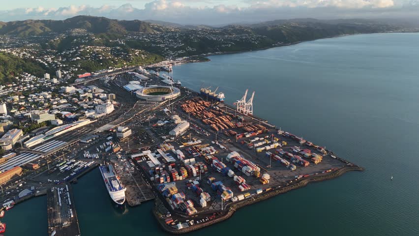 Aerial view of Wellington City port and waterfront at sunrise. 4K view of shipping containers, the stadium, and the harbor