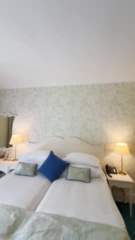 Wide angle point of view from phone camera on fancy luxury hotel bedroom in spa resort during summer vacation holiday or business trip. Social media style UGC content creation. POV on room by vlogger