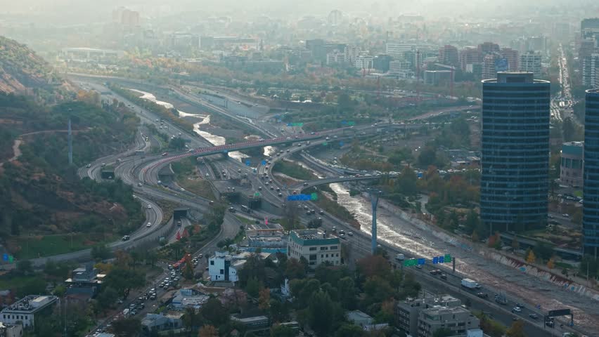 A telephoto aerial view of the large, well-developed highways of Santiago, Chile, with the great Mapocho River