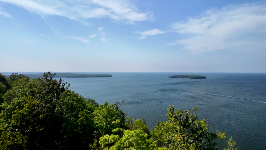 Sweeping panorama across the waters of Green Bay from Eagle Tower in Peninsula State Park, overlooking Door County shoreline, forests, and distant horizons.