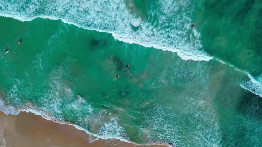 Aerial footage of ocean waves crashing on shore