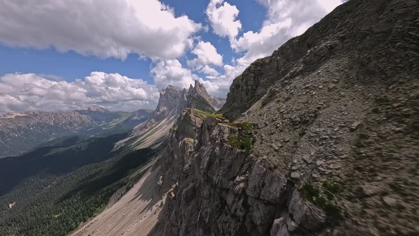 Fast cinematic FPV drone flight climbing toward the towering peaks of Seceda Ridge in the Italian Dolomites.