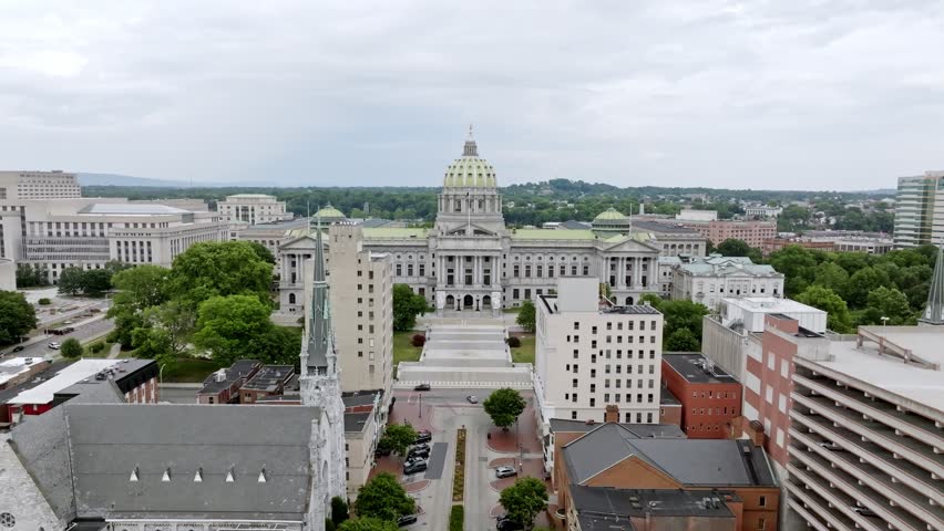 Pennsylvania state capitol building and Harrisburg, Pennsylvania skyline with drone video moving in.