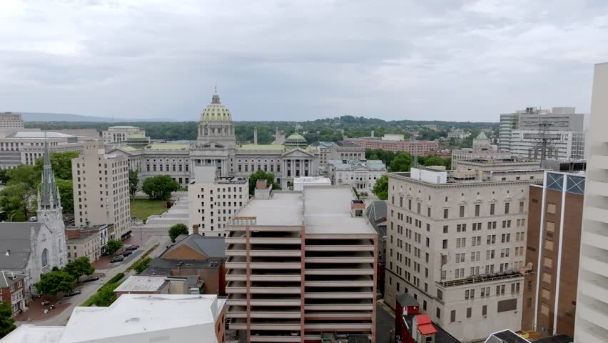 Pennsylvania state capitol building and Harrisburg, Pennsylvania skyline with drone video wide moving left to right.