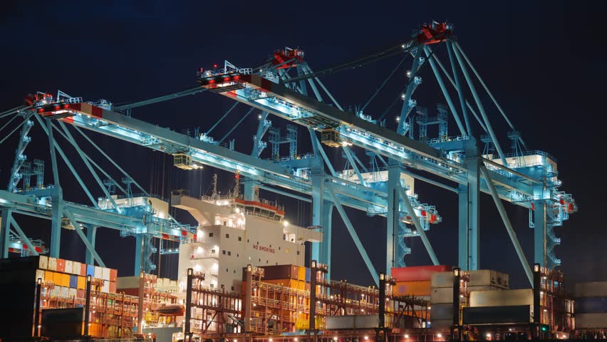 View of the Adriatic Gate Container Terminal at night with large cranes and a cargo ship in the port of Rijeka, Primorsko-goranska zupanija, Croatia.