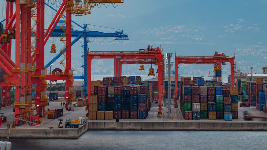 View of the Adriatic Gate Container Terminal with red gantry cranes and stacked shipping containers at the port in Rijeka, Primorsko-goranska zupanija, Croatia.