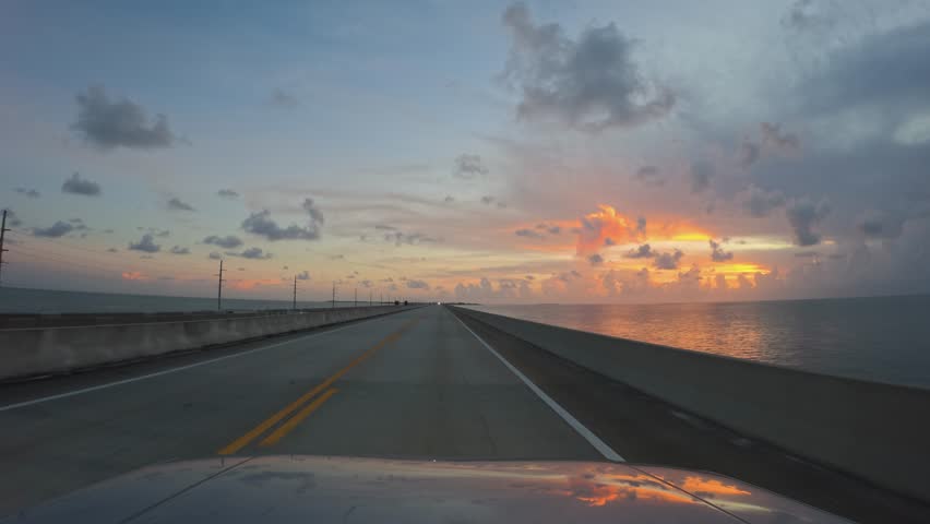 View of the Overseas Highway bridge stretching over the water during a vibrant sunset in Islamorada, Florida, United States.