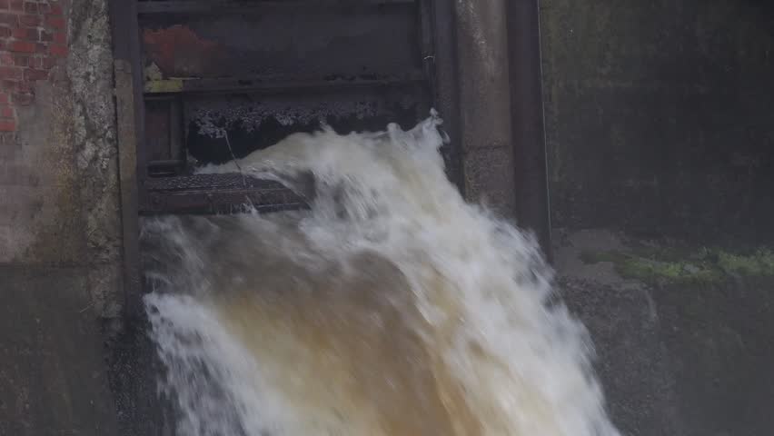 View of water rushing through the historic Molndals Kvarnby mill sluice in Molndal, Vastra Gotalands lan, Sweden.