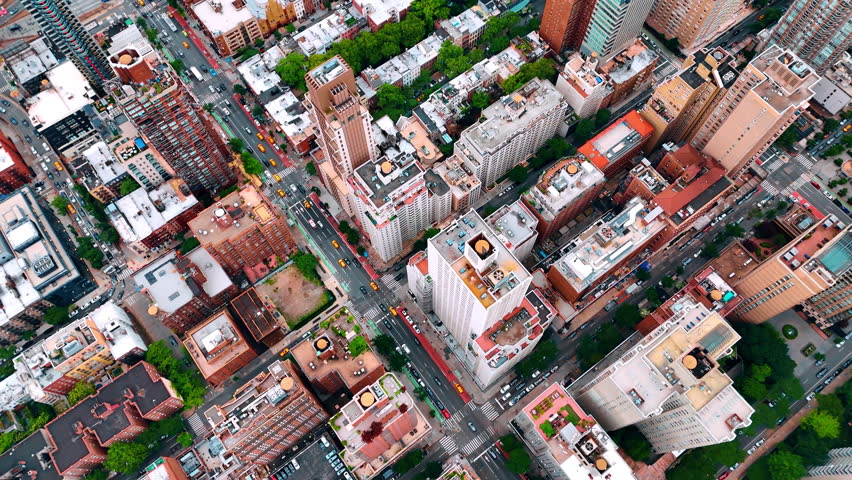 Many yellow cabs in the transport flow at daytime. Top view on the scenery of New York, USA.