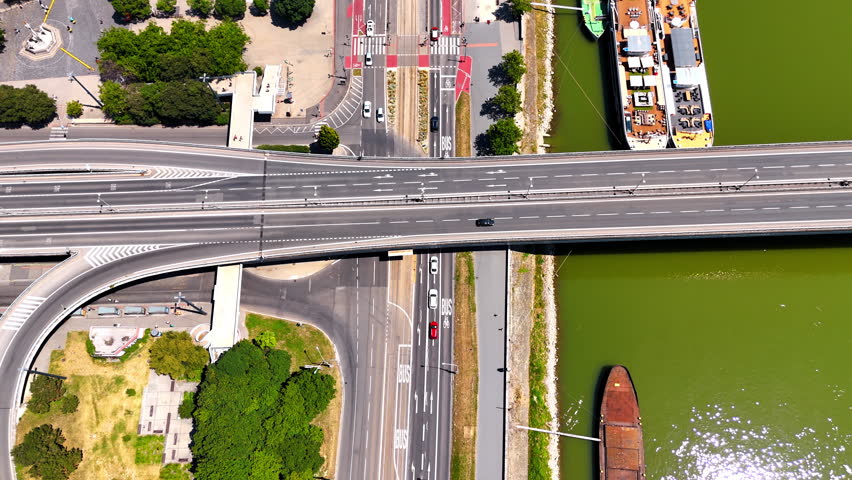 Cars move by the roads, bridges and freeways. Drone footage over the waterfront of the Danube in Bratislava, Slovakia.
