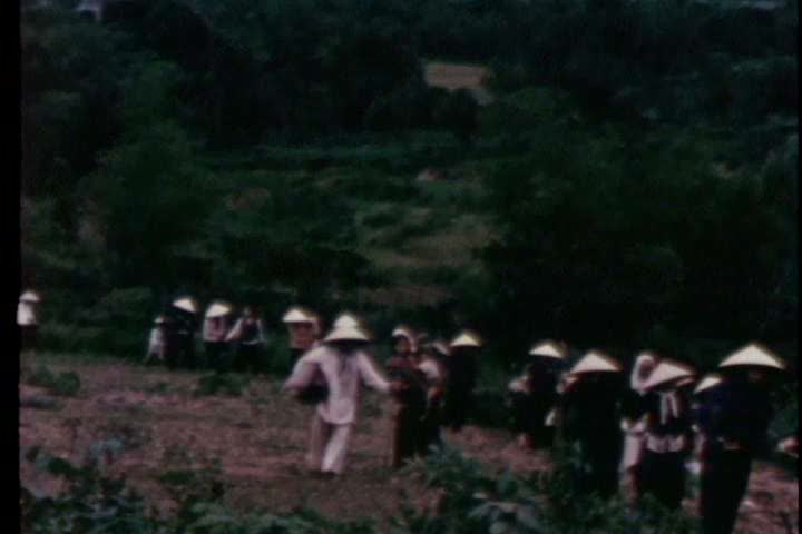 1960s - Vietnamese evacuate their homes as U.S. marines assist in the Vietnam War
