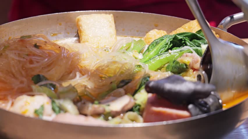 Sizzling Chinese hot pot with vermicelli noodles and vegetables