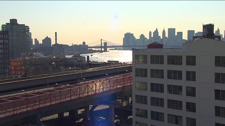 a subway train is passing in front of new york city skyline