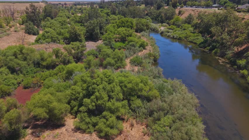 Reversing aerial drone footage pulling back over the San Joaquin River in California