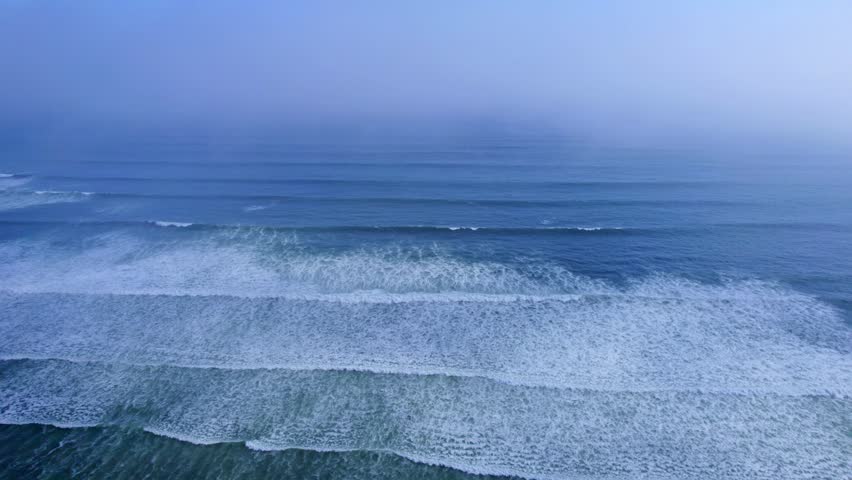 Aerial view of the Pacific Ocean waves rolling onto the shore at Costa Verde in Miraflores, Provincia de Lima, Peru.