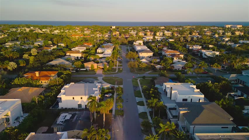 Aerial view of a residential neighborhood with palm trees and houses in Boca Raton, Florida, United States.