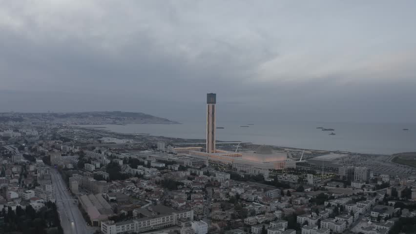 Aerial view of the Great Mosque of Algiers with its prominent minaret and dome overlooking the Mediterranean coast in Algeria.