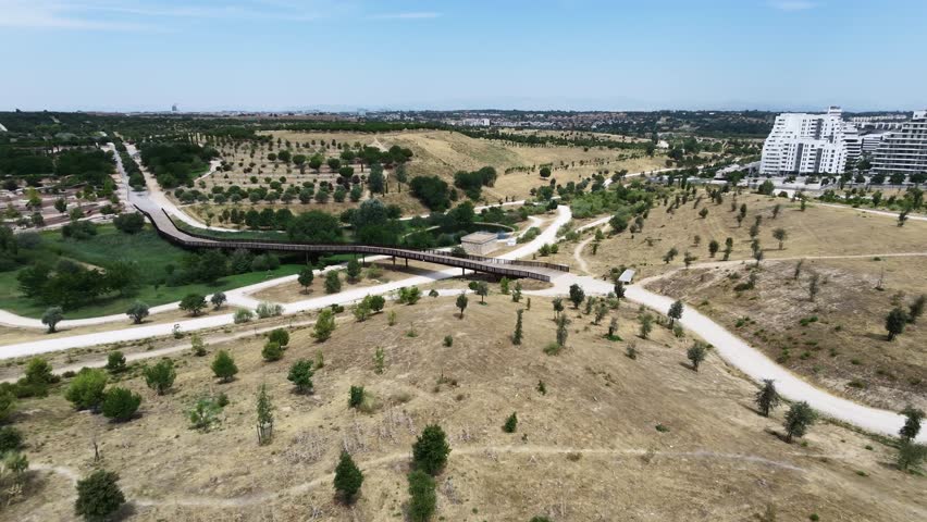 Aerial view of the lush landscape and wooden boardwalks in valdebebas park, madrid, spain