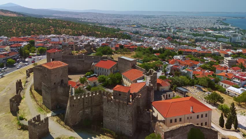 Aerial view of the Heptapyrgion Yedi Kule fortress towers and the historic Ano Poli district overlooking the sea in Thessaloniki, Greece