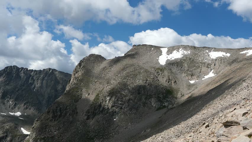 Cloud shadows over alpine mountains with lingering snow near the Continental Divide on Pawnee Pass Trail, Colorado