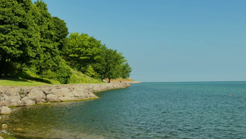 Peaceful Lake Ontario Shoreline with Trees and Rocks