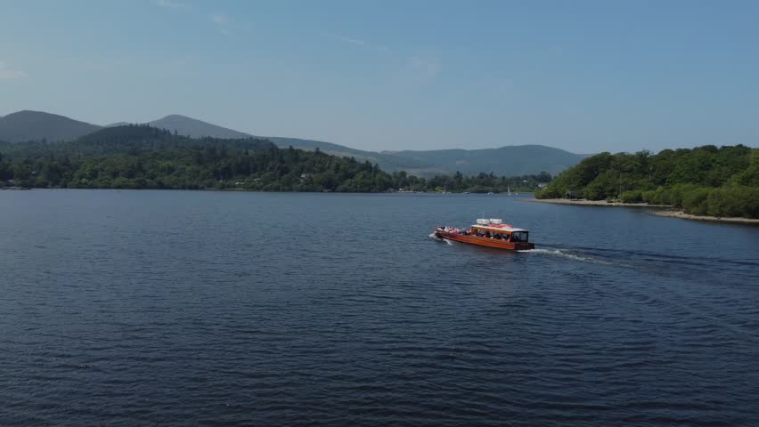 Drone 50fps. Boat on lake Keswick, Lake District National Park, Cumbria, UK. 