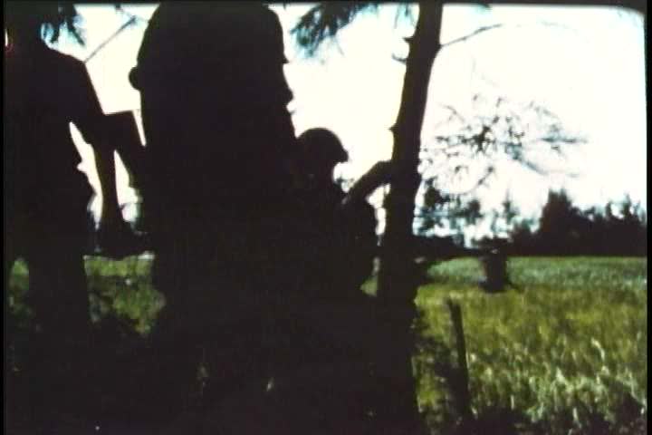1960s - United states marines march through vietnam, search for enemy combatants, and engage in a fire-fight