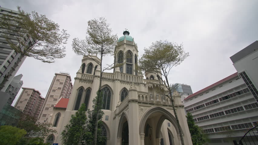 Saint Joseph Church in Singapore city featuring historic Catholic architecture surrounded by modern office skyscrapers creating a unique urban landscape for tourism in Asia